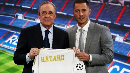 Eden Hazard poses a picture while signing for Real Madrid.